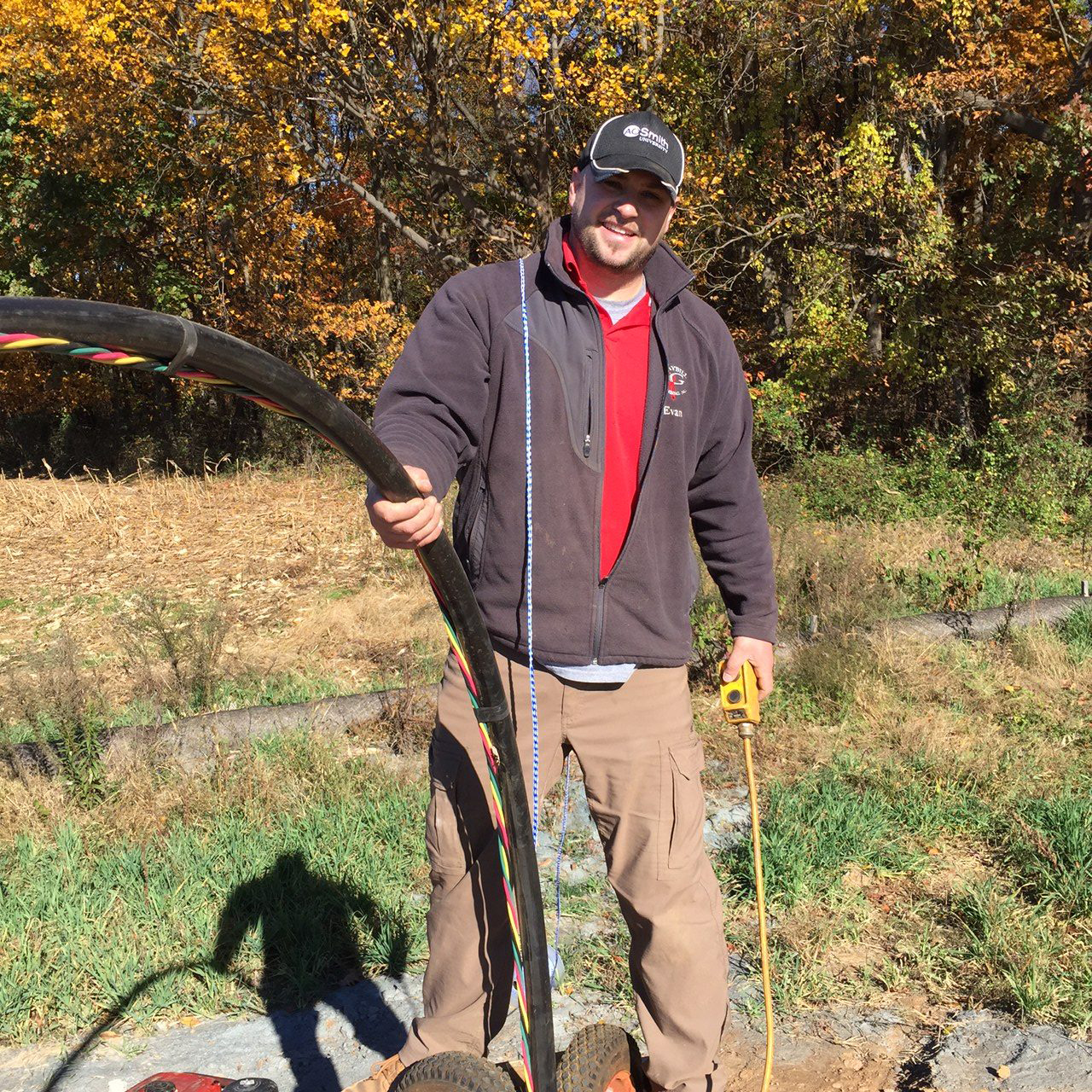 evan graybill holding a large plumbing device