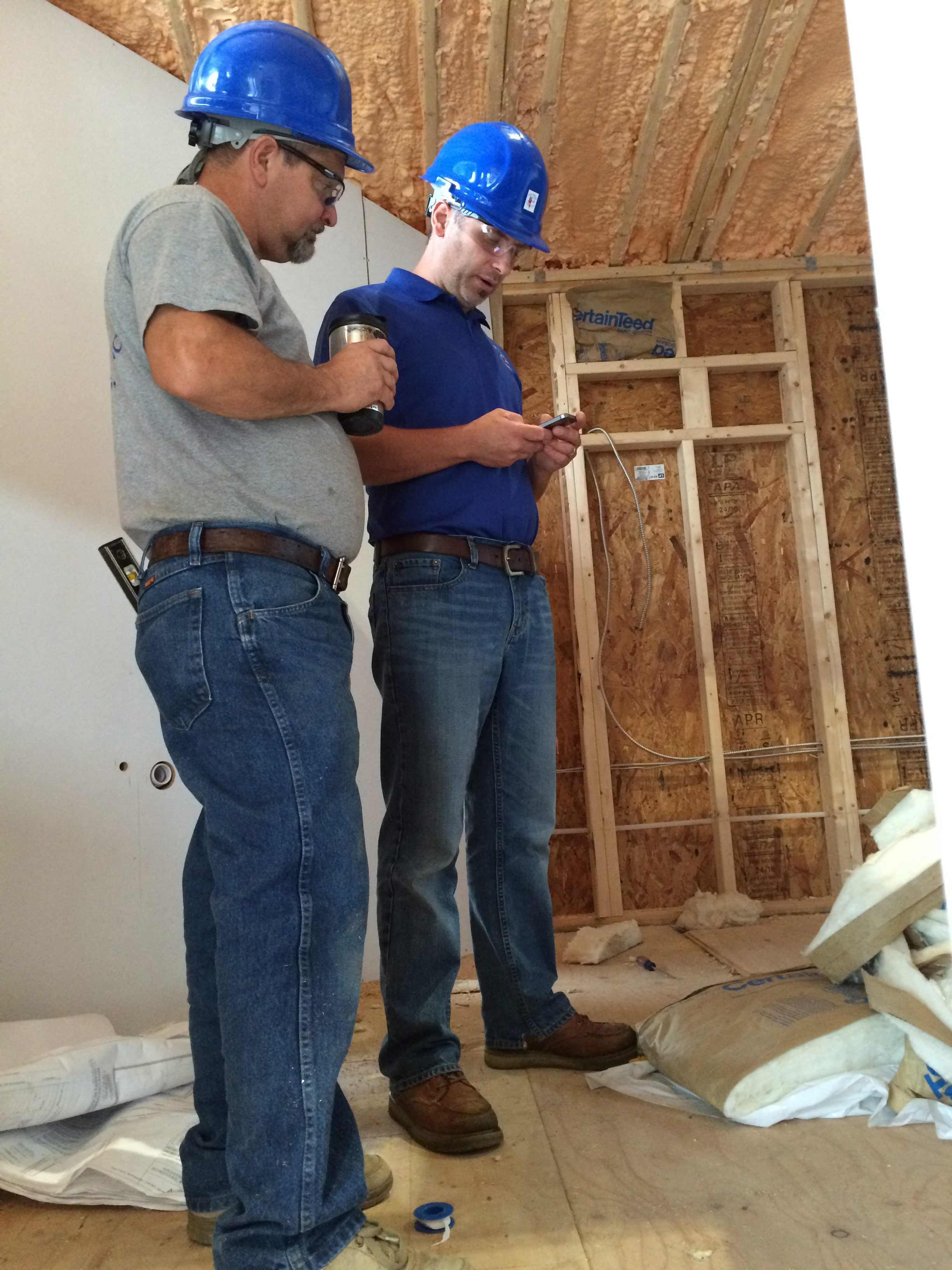 two men in hardhats at a new plumbing jobsite
